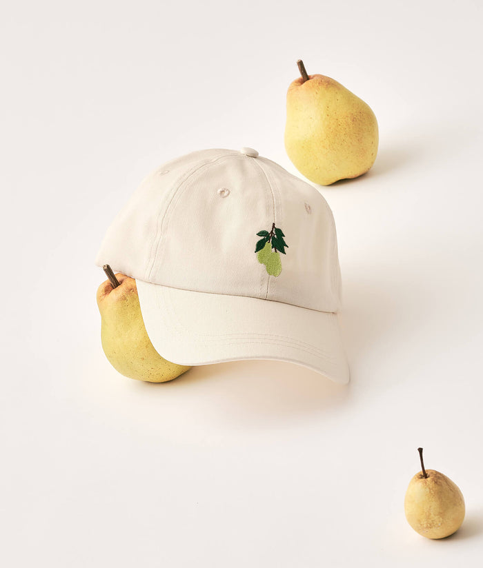 Beige cap with pear design on a white background