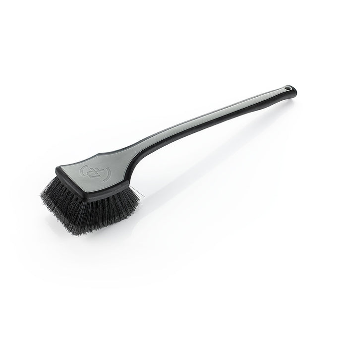 A grey Detail Factory fender well brush on a white background.