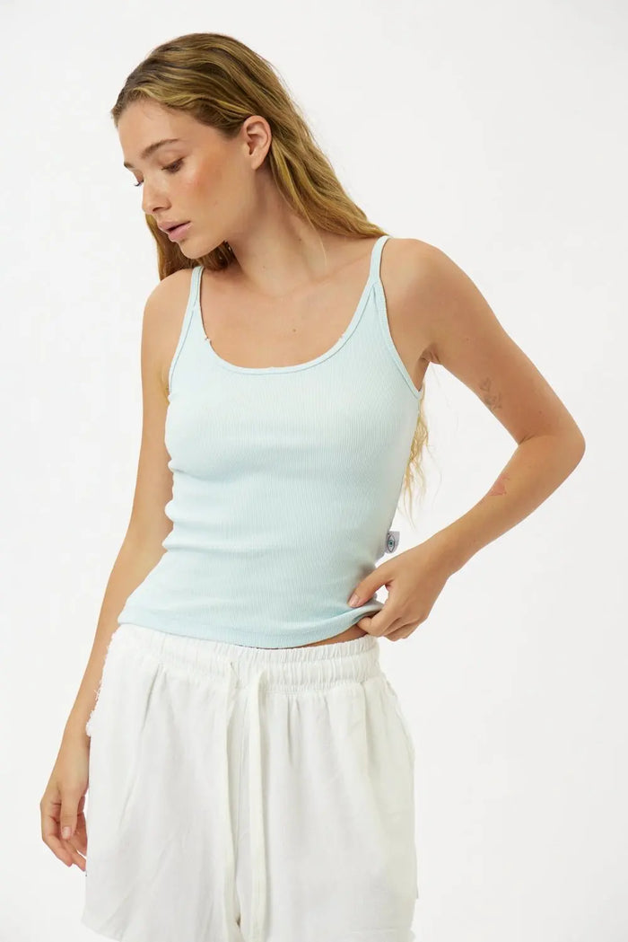 Slim Cotton Tank Top in Sky Blue worn by a woman with long blonde hair and white shorts