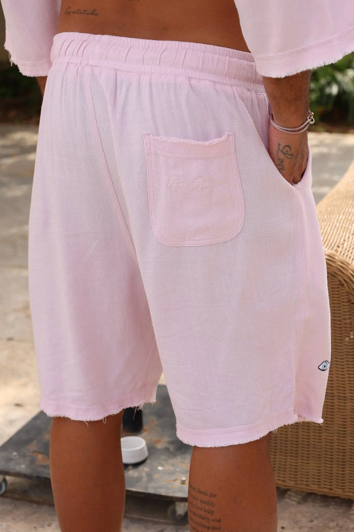 Soft Linen Bermuda Shorts in Baby Pink with an elastic waistband and a back pocket with embroidered logo