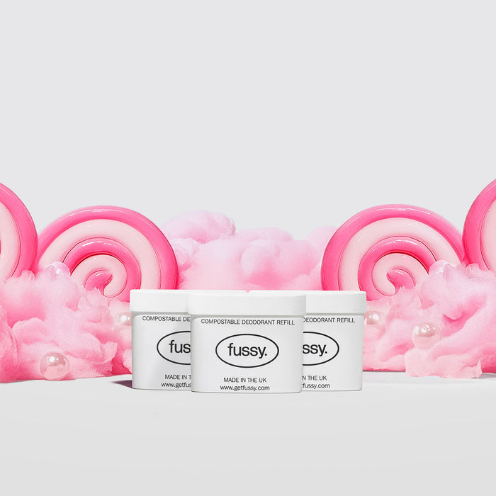 Fussy's Sugar Crush Deodorant Refill Packs featuring three refill packs set against a backdrop of cotton candy and pink and white lollipops