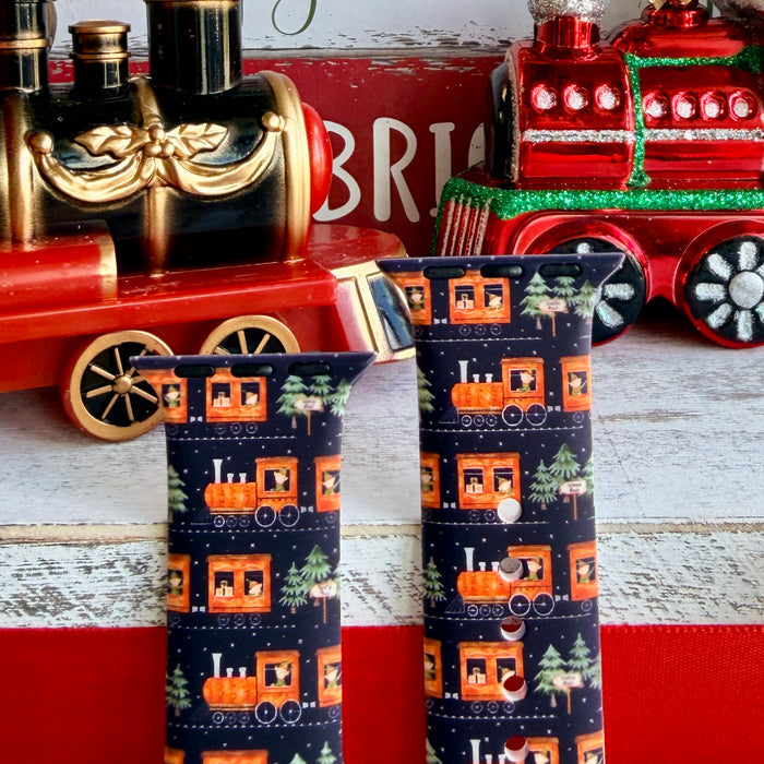 Smartwatch with a festive band on a decorative background with Christmas-themed items.