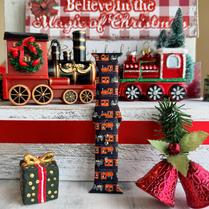 Smartwatch with a festive band on a decorative background with Christmas-themed items.