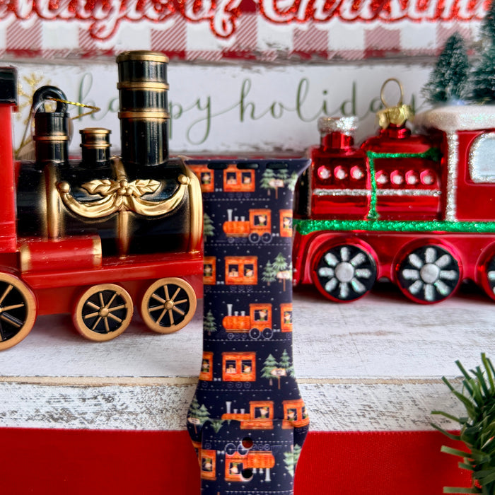 Smartwatch with a festive band on a decorative background with Christmas-themed items.