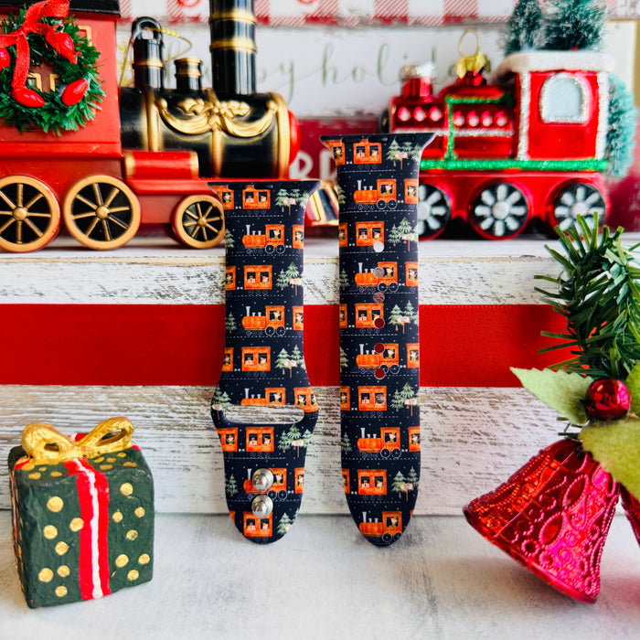 Smartwatch with a festive band on a decorative background with Christmas-themed items.