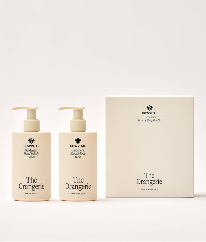 Two bottles of 'The Orangerie' hand and body lotion with a matching box on a white background.