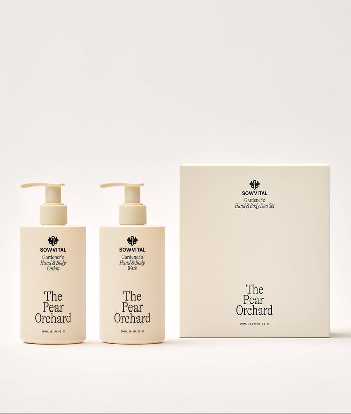 Two bottles and a box of 'The Pear Orchard' hand and body wash and lotion on a white background
