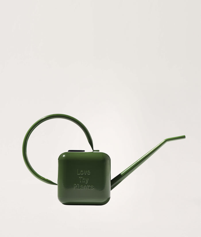 Green watering can with 'Love Thy Plants' text on a light gray background.