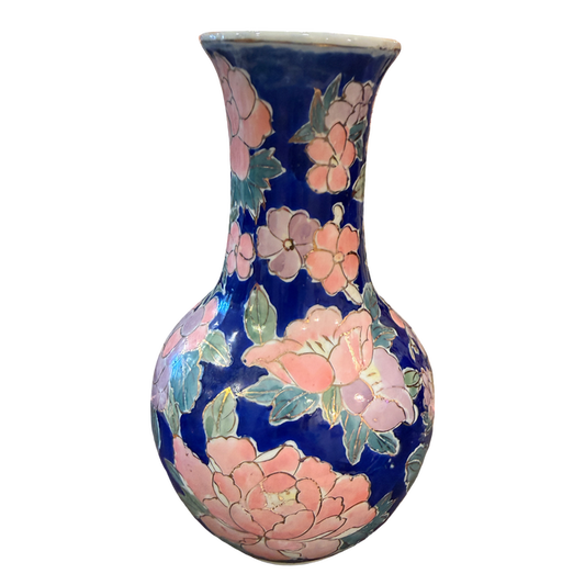 A ceramic vase with a dark blue glaze decorated with large pink flowers and green leaves, shown against a plain white background.