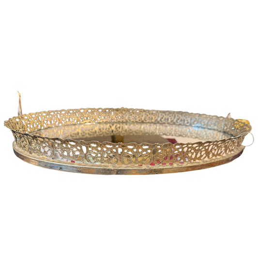 Decorative gold metal tray on a white background